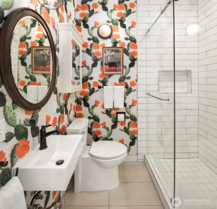 One of the guest baths features a spacious walk-in shower complemented by designer tile and upscale fixtures.