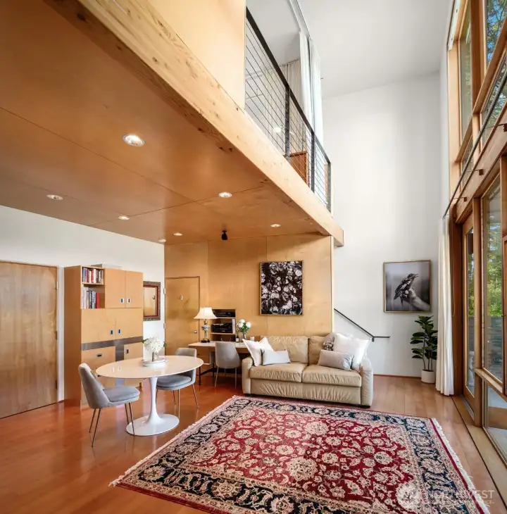 Walls of windows with designer window treatments flood the home with natural light while perfectly framing the breathtaking water views beyond.