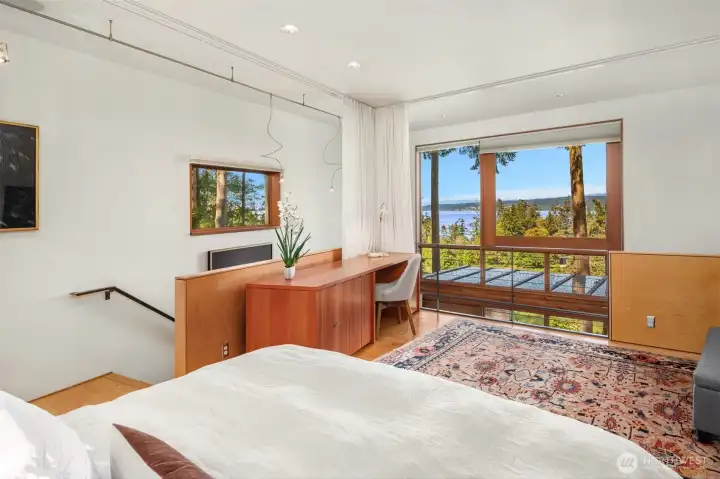 Upstairs, breathtaking views are complemented by custom blackout window treatments, radiant heated floors, and a built-in desk designed for comfort and functionality.