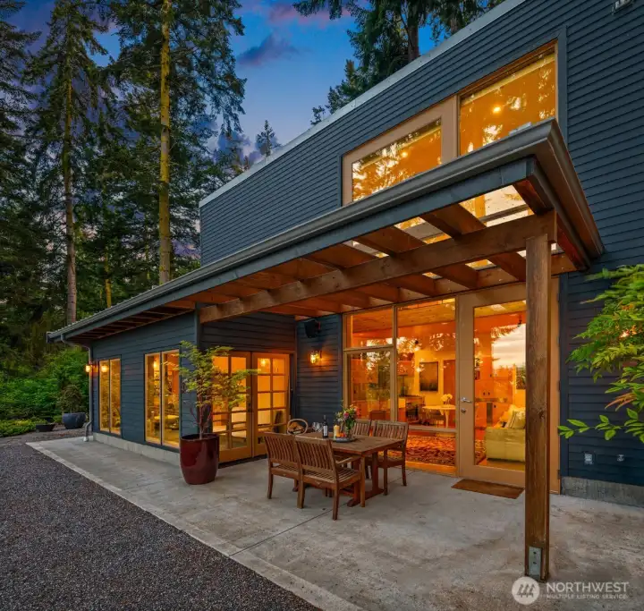 The outdoor spaces showcase board-formed concrete walls, designer lighting, and seamless indoor-outdoor open-concept living designed for effortless entertaining.
