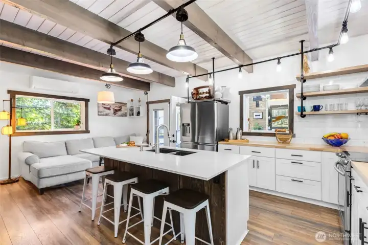 You will love preparing meals in the well-appointed spacious kitchen with quartz island, butcher block counters, stainless appliances, and abundant storage.