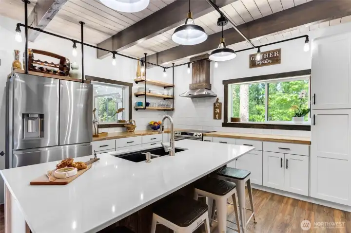 Enjoy views of the lake from this central kitchen window. Open shelving adds an attractive storage space.