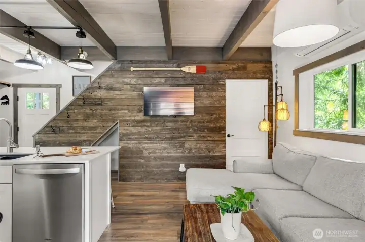 Reclaimed dock wood forms this artistic ship-lapped wall. Next to the front entry is a convenient storage area with bench and coat hooks.