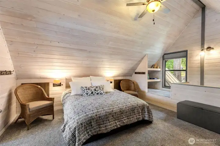 Cozy reading nook with shelving by the window.