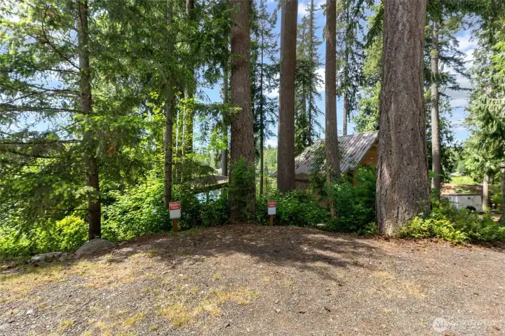Two designated parking spaces above the house off the gravel road.