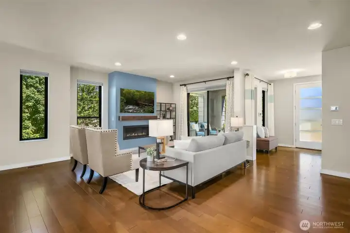 Living room with sliding doors to the patio. The fireplace with accent wall and custom mantel is just one of the upgrades and sophisticated design touches the owner added Living room with sliding doors to the patio. The fireplace with accent wall and custom mantel is just one of the upgrades and sophisticated design touches the owner added