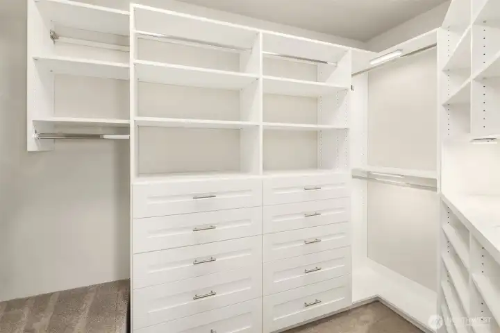 Large, fully kitted out closet for the primary suite giving a place for everything Large, fully kitted out closet for the primary suite giving a place for everything