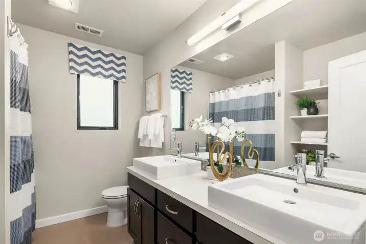 The upper floor bathroom with dual vanities and tub. Not shown is additional storage - so practical and stylish The upper floor bathroom with dual vanities and tub. Not shown is additional storage - so practical and stylish