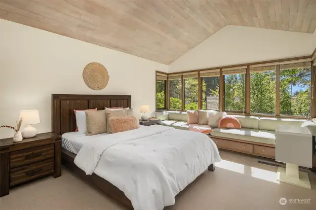 So much natural light in this large upstairs bedroom with big windows & cozy reading nook with built-in window seat.