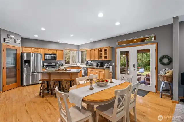 Kitchen with gas range and large pantry opens to dining and living