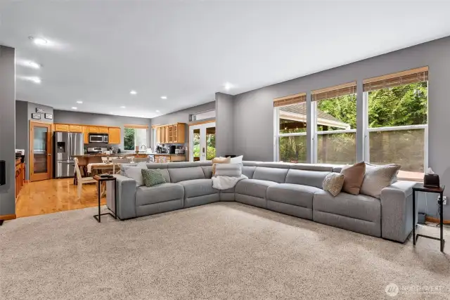 Living room opens to dining and kitchen and looks out to backyard retreat