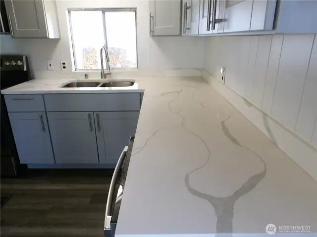 Remodeled kitchen.  New appliances, quartz, new cabinets and flooring.