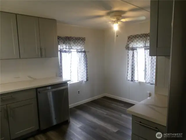 You are standing at the sink looking at the front door.