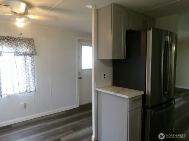 You are standing at the sink looking at the front door.