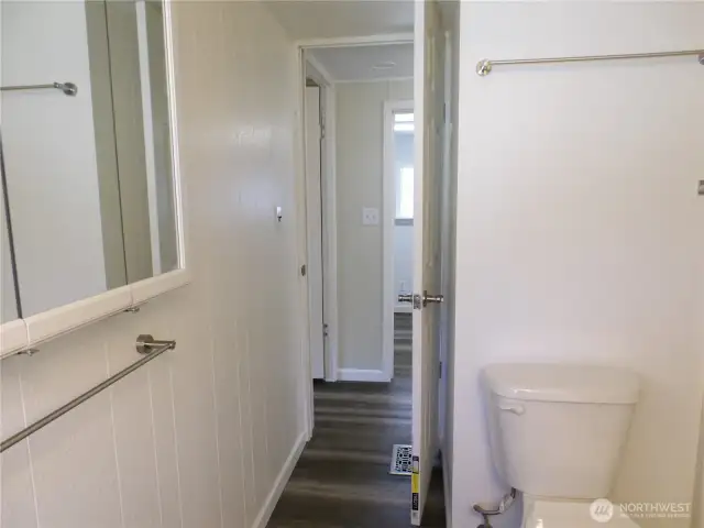 Leaving bathroom.  Go across hall to laundry room.