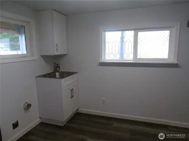 Laundry room with washer/dryer hook up and handy sink and cabinet.