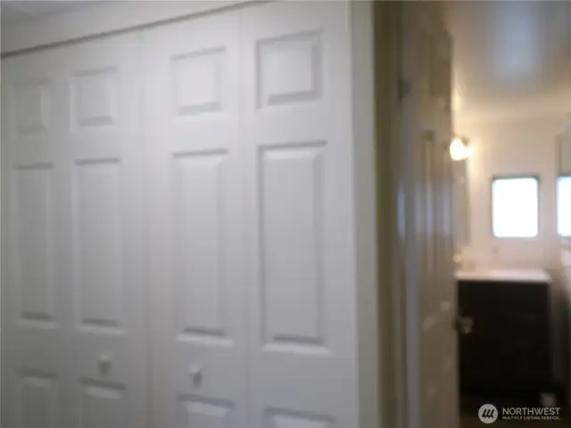 Hall closet next to the bathroom.  New doors throughout this house.