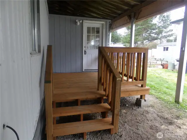 New back porch under carport that goes into the laundry/mud room.