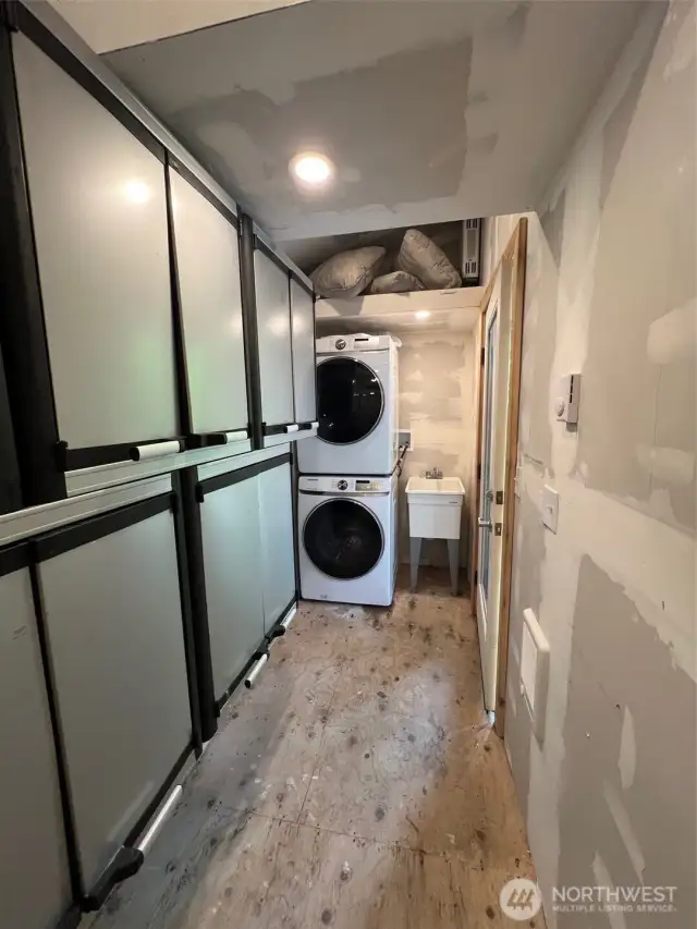 INSIDE THE SHED WITH WASHER/DRYER/UTILITY SINK AND STORAGE CABINETS