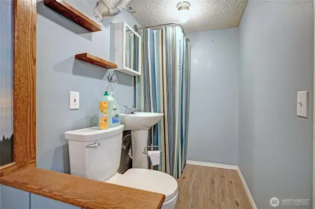 Unit 1 half bath on lower level located next to the office.