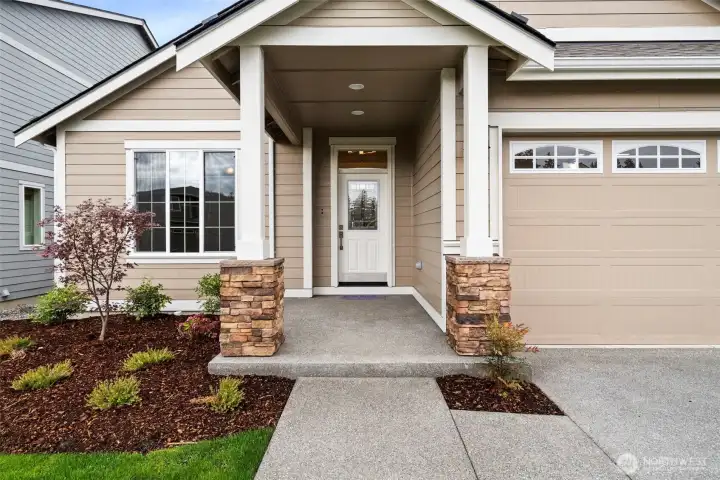 Our Redwood one story floor plan has the perfect covered porch entry with stone accents to welcome you and your guests.