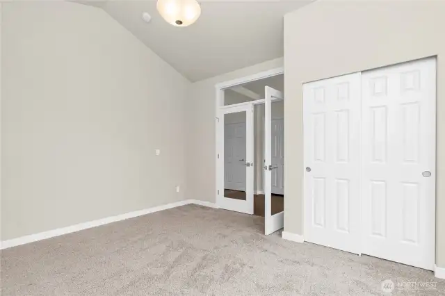 Off the front entry hall,  glass French doors open into what could be a den/office space or a 3rd bedroom.