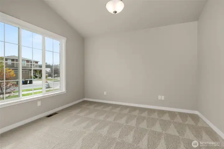 Off the front entry hall, clear glass doors open into what could be a den/office space or a 3rd bedroom.