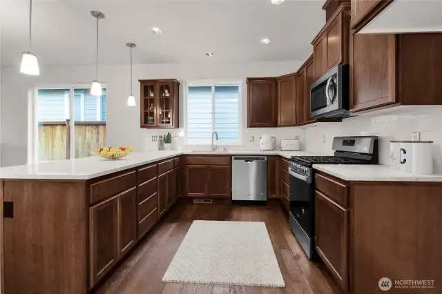 Virtually staged photo to highlight the maple cabinetry and functionality of the kitchen