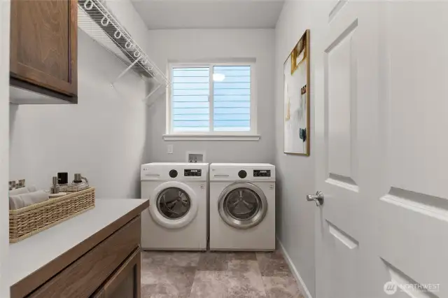 Virtually staged photo to show features of cabinetry, drying rack- and design.