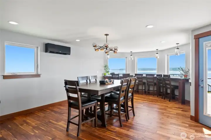 Dining room with with eat up bar at the windows. Can seat up to 24 people