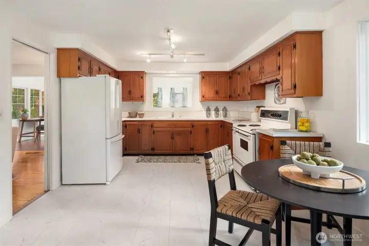 The large kitchen has tons of space for a table for more casual meals. Plus there loads of room to reimagine the kitchen to fit your needs.