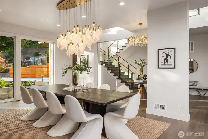 An elegant dining space where sculptural lighting and modern design create the perfect setting for memorable gatherings.