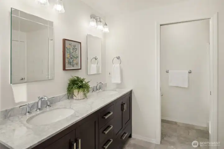 Primary bathroom includes a double vanity and a walk-in shower.