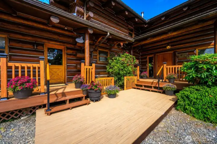 Multiple doors open seamlessly to expansive sun-drenched decks designed for entertaining, relaxing, and soaking in the peaceful surroundings.