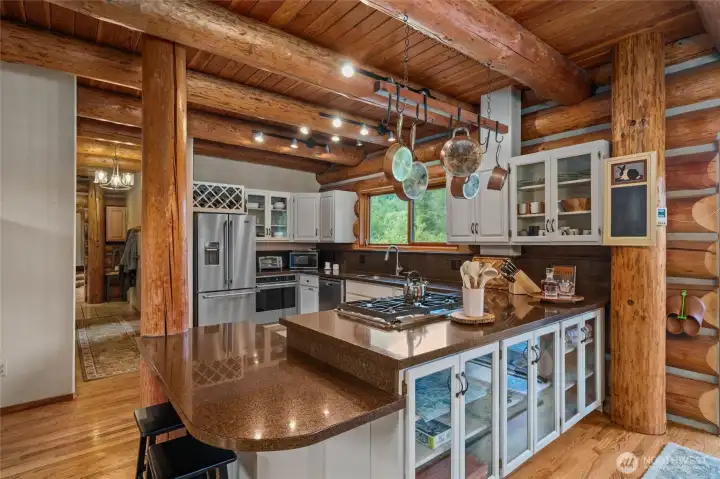 Custom cabinetry with elegant glass fronts beautifully showcases your gorgeous dishes while adding timeless character and charm to the kitchen.