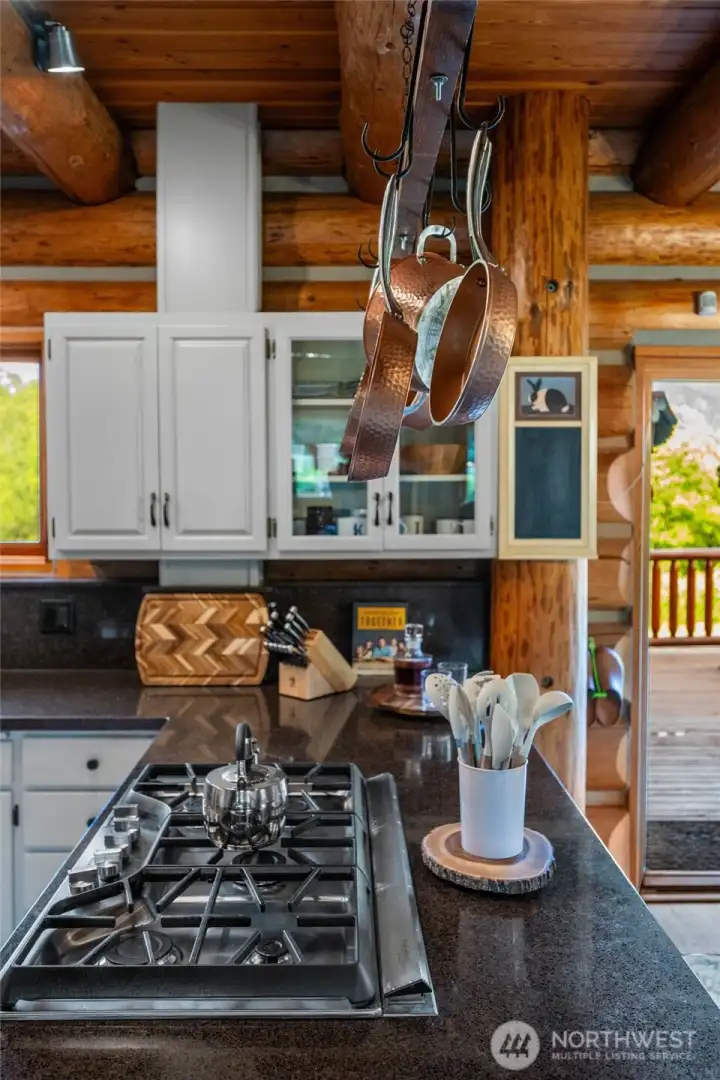 A gas cooktop and generous bar seating open seamlessly to the living spaces, creating the perfect flow for entertaining and gathering.