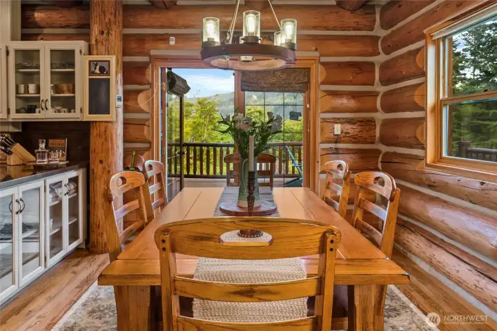 French doors open from the dining space to the expansive entertainment deck, blending indoor and outdoor living with ease.