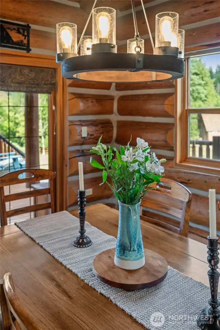 This stunning log home makes hosting and entertaining a delight, blending the warmth and coziness of natural log elements with inviting gathering spaces throughout.