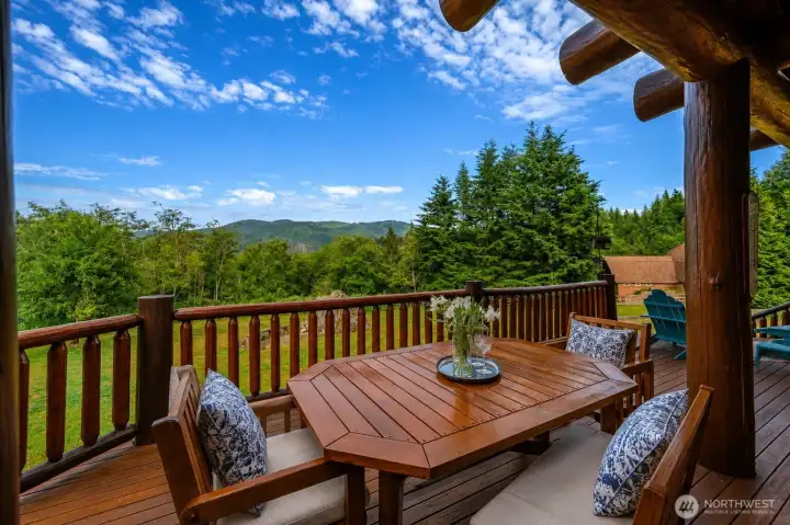 Imagine unforgettable outdoor gatherings on the expansive deck that stretches the entire length of the home, designed for entertaining, dining, and relaxing in the fresh mountain air.