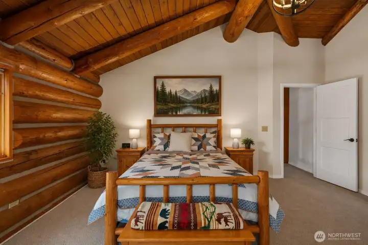 The primary suite features a huge walk-in closet and French doors that open wide to bring in the fresh air and peaceful surrounding views.