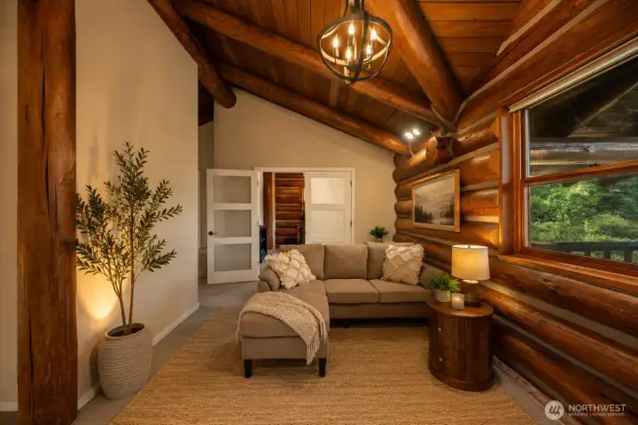 The expansive sitting area within the primary suite flows seamlessly into a private office, creating the perfect space to relax and work from home.