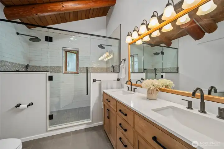 The brand-new bathroom features dual sinks, quartz countertops, and a spa-inspired design that blends luxury with everyday comfort.