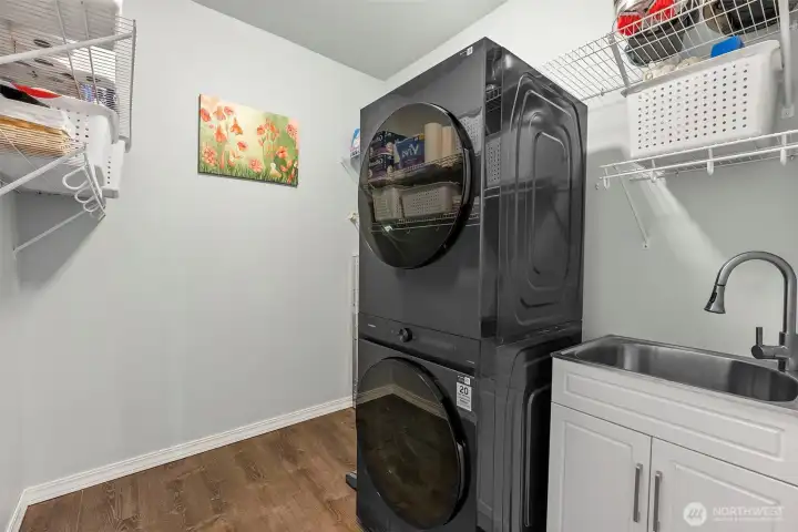 Main floor laundry with sink and shelving.