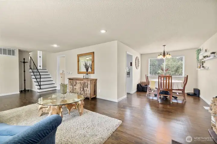 Warm hardwood flooring expands throughout the main level of the home