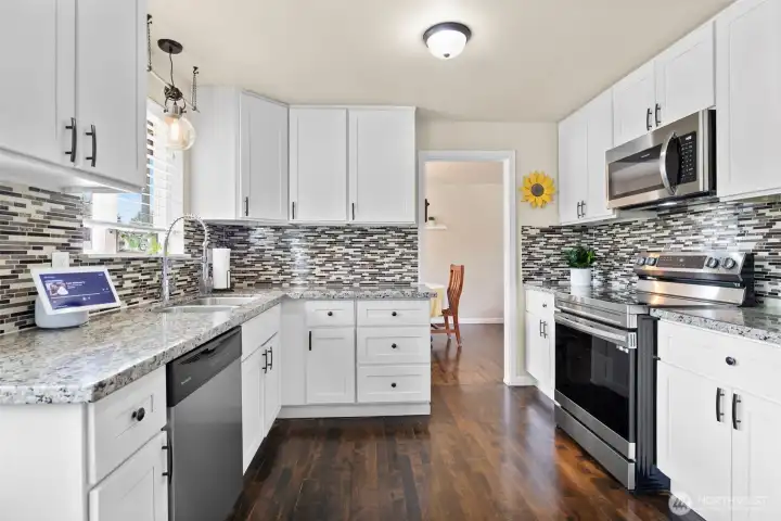 The beautiful kitchen offers lots of soft close cabinetry with decorative pulls & an upgraded sink & faucet