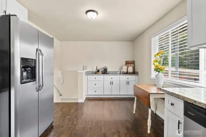 The casual kitchen dining space is the perfect spot to start your day enjoying the tranquil back yard view with your cup of coffee or tea