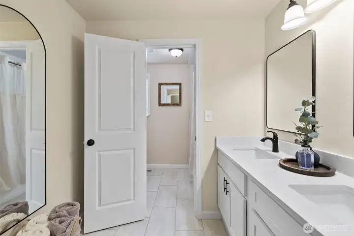 The remodeled bath features all new granite countertops, double sinks, decorative mirrors & fixtures.