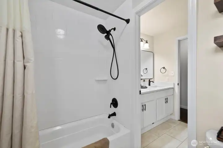 The separate shower space allows the bathroom to be easily shared. The shower surround & toilet are new and the tile flooring blends beautifully with the fresh paint