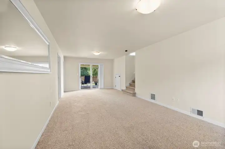 The bonus room also has access to the back yard and the white door on the right is added storage