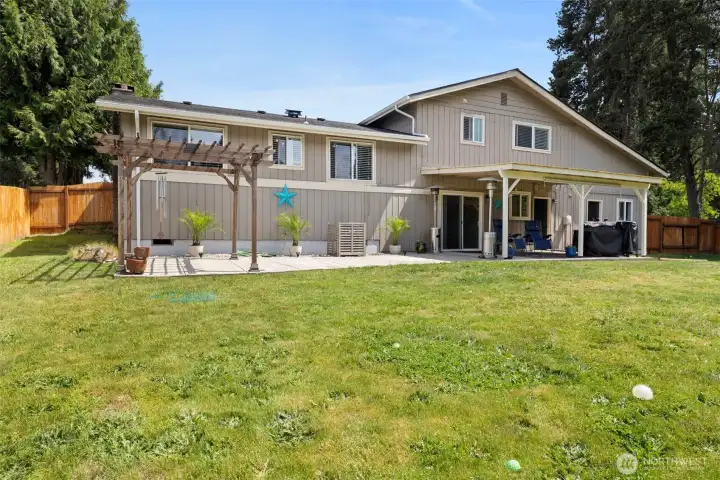 The back patio is huge & allows space to BBQ, dine under the stars or relax under cover with your favorite beverage, even on a rainy day. The space is already wired & ready for a hot tub